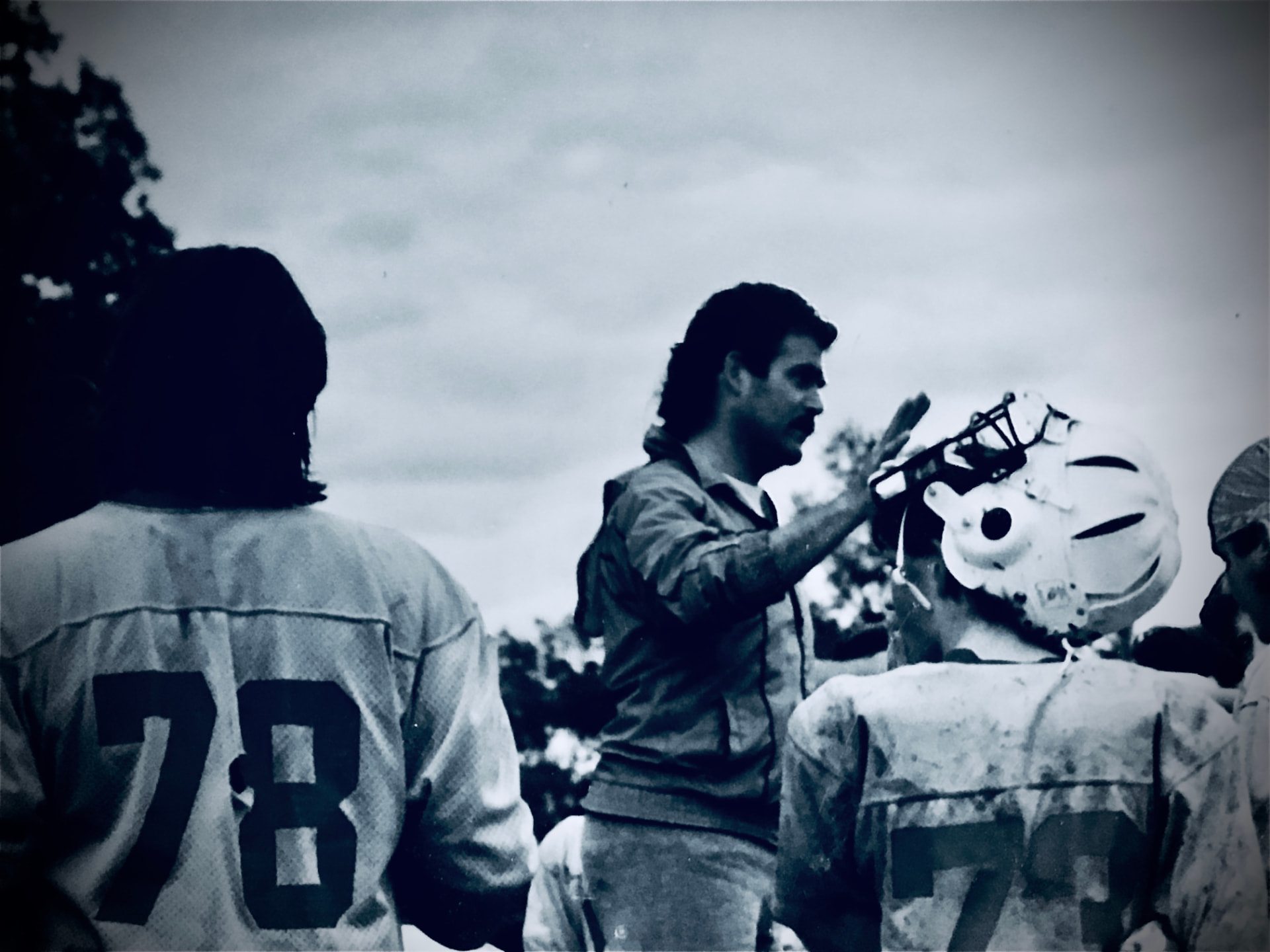 Coach with players on the field